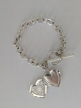 Silver tone chain bracelet with functional intricate heart locket